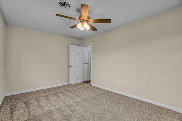 carpeted spare room featuring ceiling fan