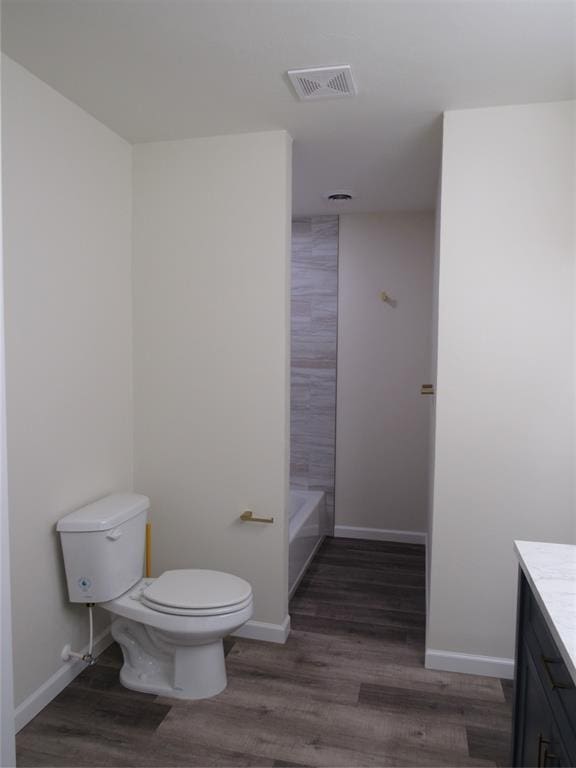 full bathroom with toilet, vanity, shower / bathtub combination, and hardwood / wood-style flooring