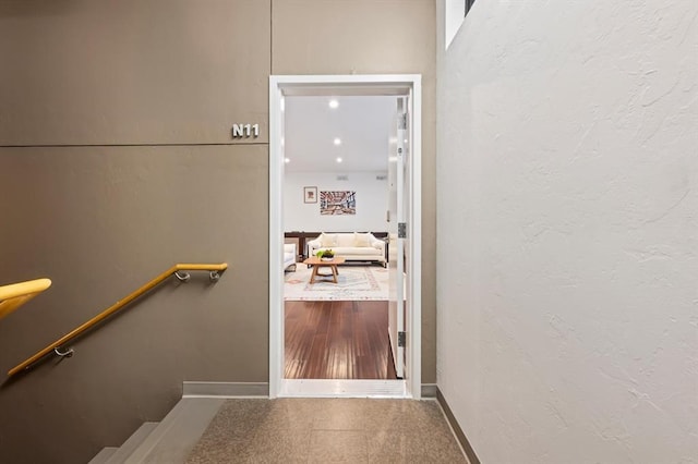 stairway with hardwood / wood-style flooring