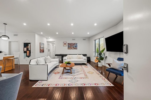 living room with dark hardwood / wood-style floors