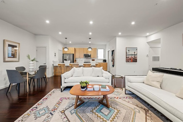 living room with dark hardwood / wood-style flooring