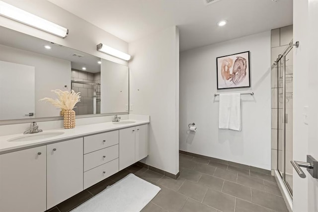 bathroom featuring tile patterned floors, vanity, and an enclosed shower