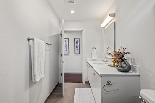 bathroom featuring tile patterned floors, vanity, and toilet