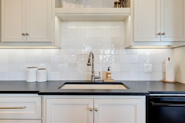 kitchen with white cabinets, decorative backsplash, dishwasher, and sink