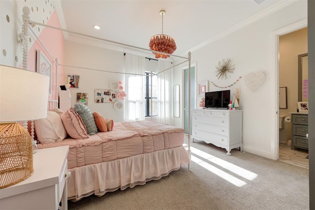 bedroom with carpet flooring, ensuite bath, and crown molding