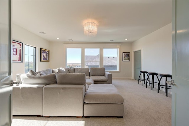 living room with a notable chandelier and light carpet