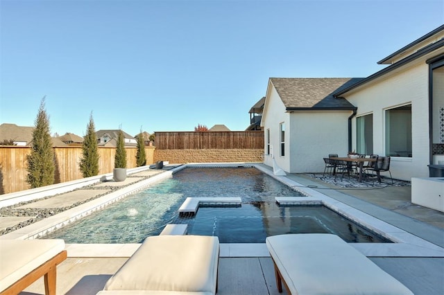 view of swimming pool featuring an in ground hot tub, pool water feature, and a patio area