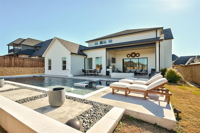 back of house with a patio, a fenced in pool, and an outdoor hangout area