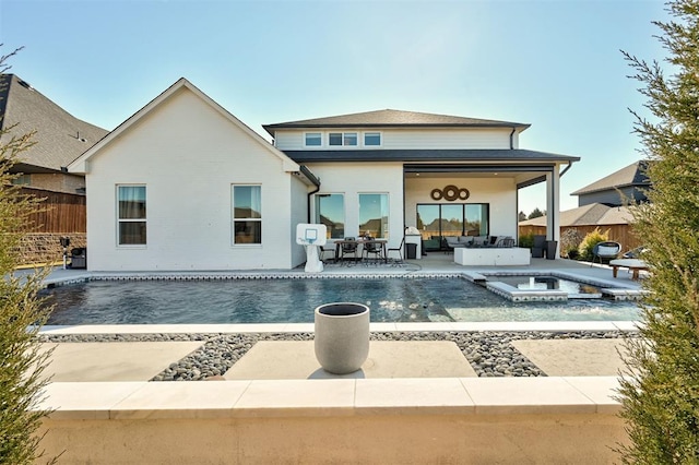 back of property with an outdoor living space, a patio area, and a pool with hot tub