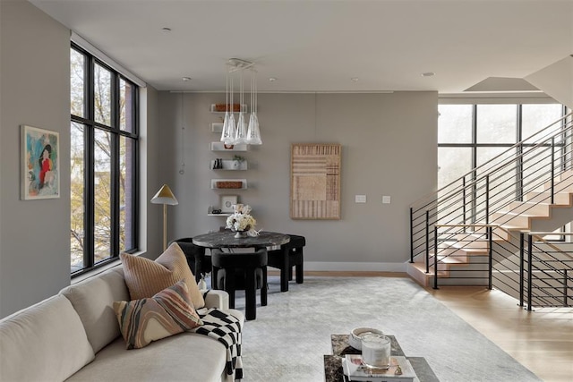 living room featuring plenty of natural light, expansive windows, and light hardwood / wood-style flooring