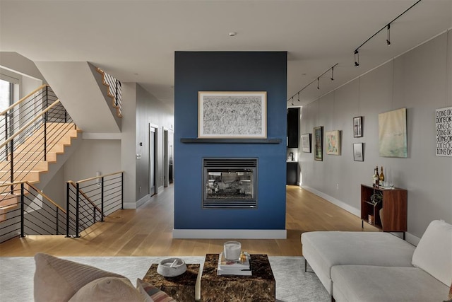 living room featuring light hardwood / wood-style floors and track lighting