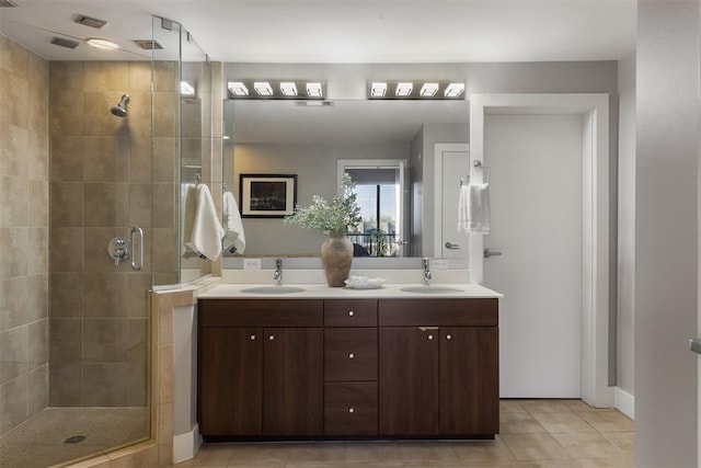 bathroom featuring tile patterned flooring, vanity, and a shower with shower door