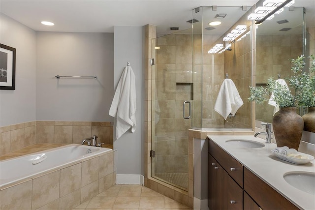 bathroom featuring tile patterned flooring, vanity, and separate shower and tub