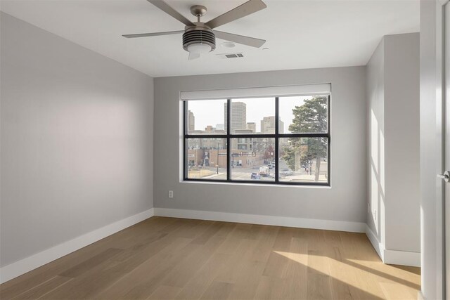 spare room with ceiling fan and light hardwood / wood-style floors