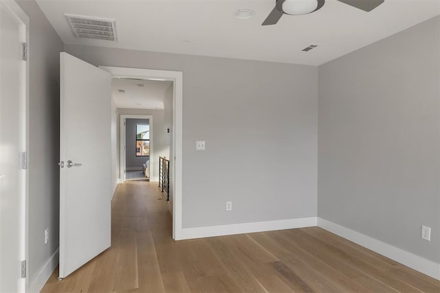 spare room with light hardwood / wood-style flooring and ceiling fan