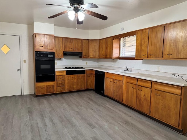 kitchen featuring ceiling fan, sink, black appliances, light hardwood / wood-style floors, and range hood