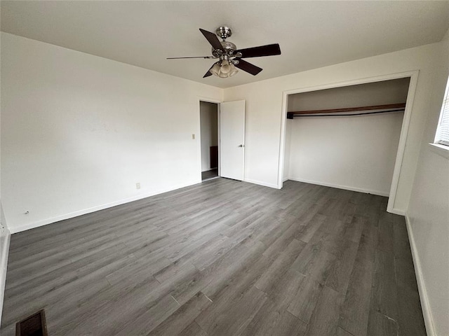 unfurnished bedroom featuring ceiling fan, a closet, and dark hardwood / wood-style floors