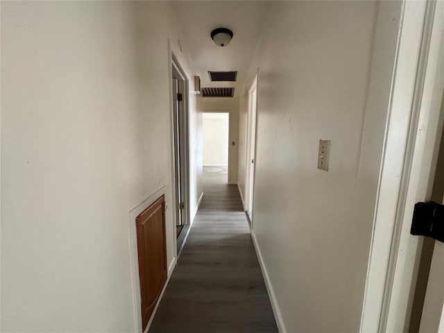 corridor featuring dark hardwood / wood-style floors