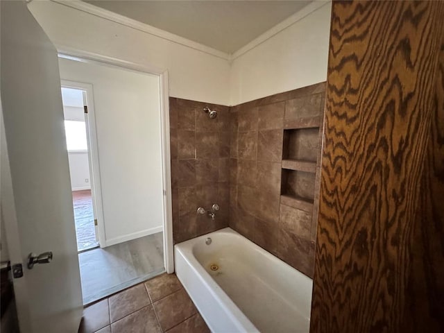 bathroom featuring tile patterned flooring, tiled shower / bath combo, and crown molding