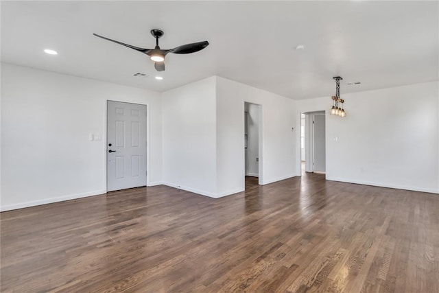 spare room featuring ceiling fan and dark wood-type flooring