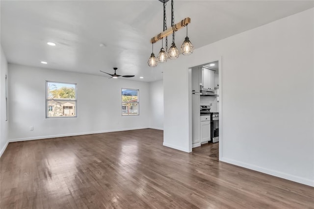 interior space featuring ceiling fan and dark hardwood / wood-style floors