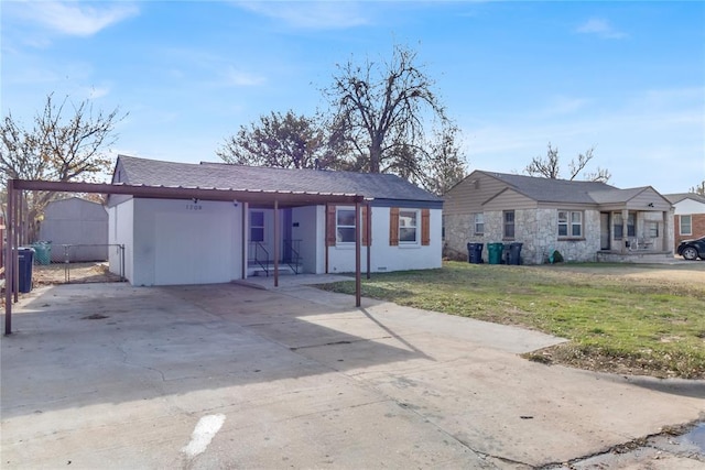 single story home featuring a front yard and a carport