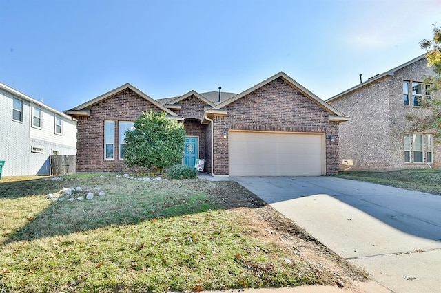 view of front of property featuring a garage and a front lawn