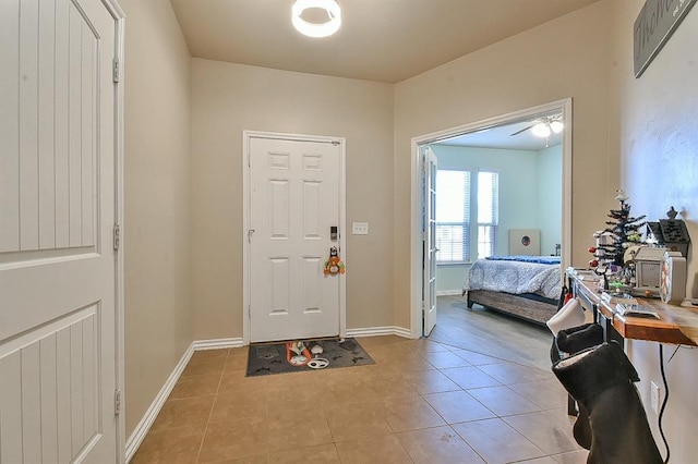 foyer featuring ceiling fan and light tile patterned floors