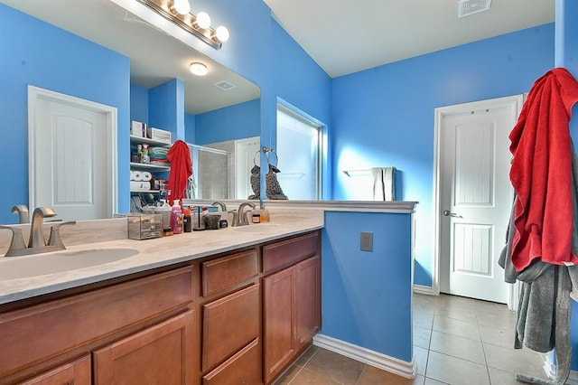 bathroom with vanity, tile patterned floors, and walk in shower