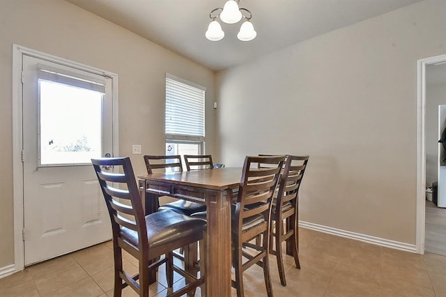 tiled dining area with plenty of natural light and a chandelier