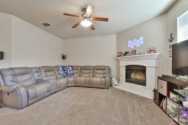 carpeted living room with ceiling fan