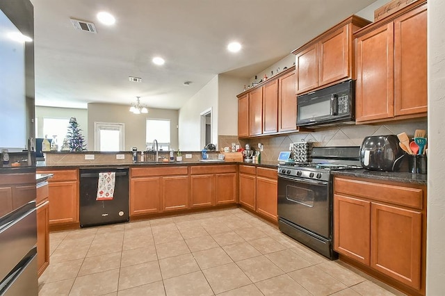 kitchen featuring tasteful backsplash, sink, black appliances, light tile patterned floors, and an inviting chandelier