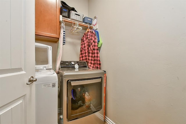 laundry area with cabinets and separate washer and dryer