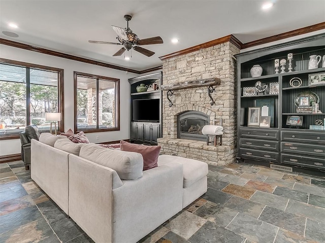 living room featuring a stone fireplace, crown molding, and ceiling fan