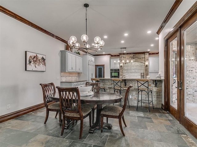 dining room with crown molding, french doors, and an inviting chandelier