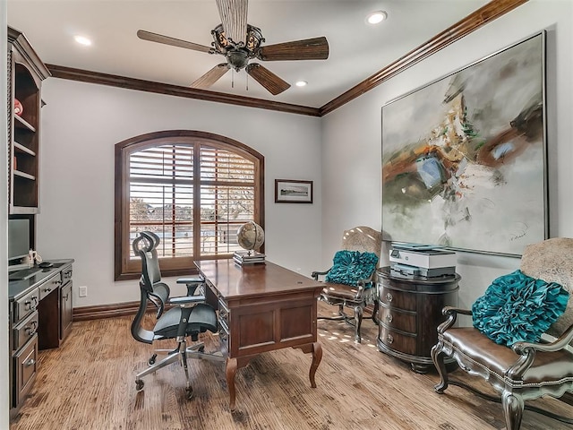 office area with light hardwood / wood-style floors, ceiling fan, and ornamental molding