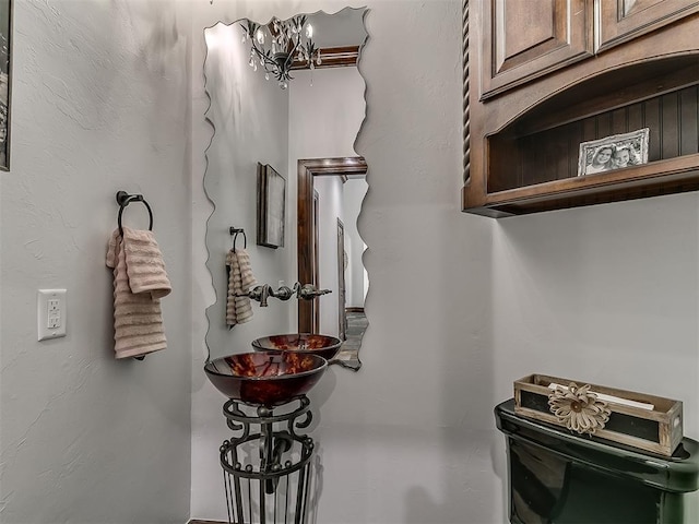 interior space with toilet and a notable chandelier