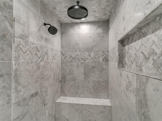 interior details featuring tiled shower