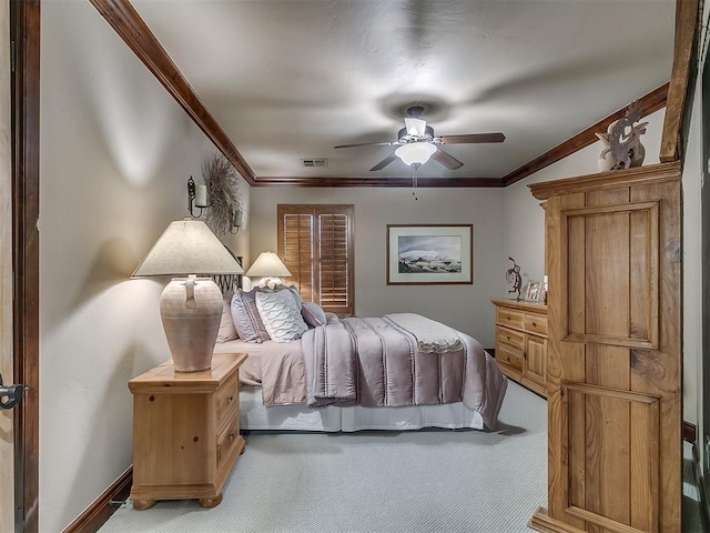 bedroom with ceiling fan, light colored carpet, and crown molding