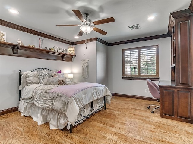 bedroom featuring ceiling fan, light wood-type flooring, and crown molding