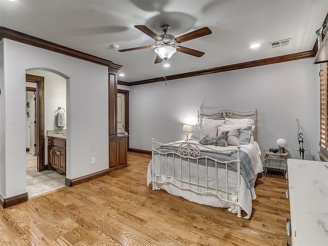 bedroom with connected bathroom, ceiling fan, crown molding, and light hardwood / wood-style floors