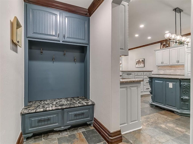 mudroom with an inviting chandelier and crown molding