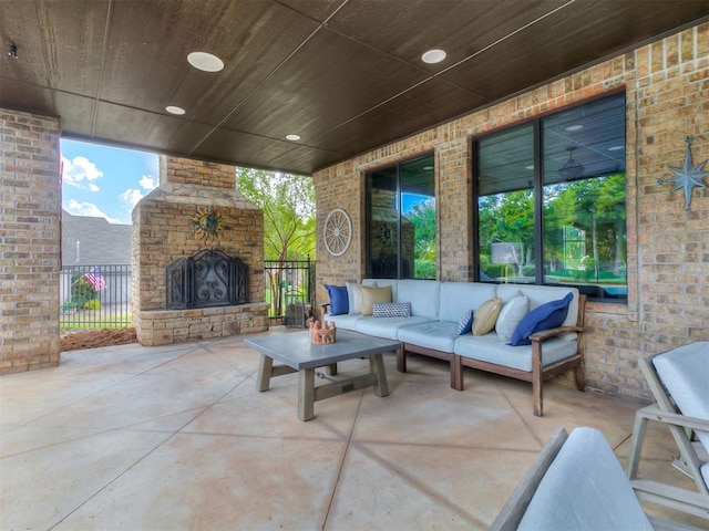 view of patio with an outdoor living space with a fireplace