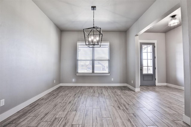 interior space featuring a notable chandelier and light hardwood / wood-style floors