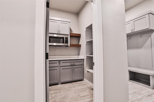 kitchen featuring gray cabinets and light wood-type flooring