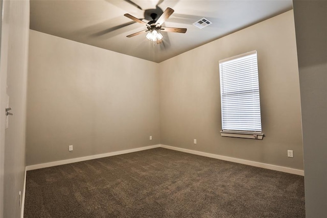 empty room featuring ceiling fan and dark colored carpet