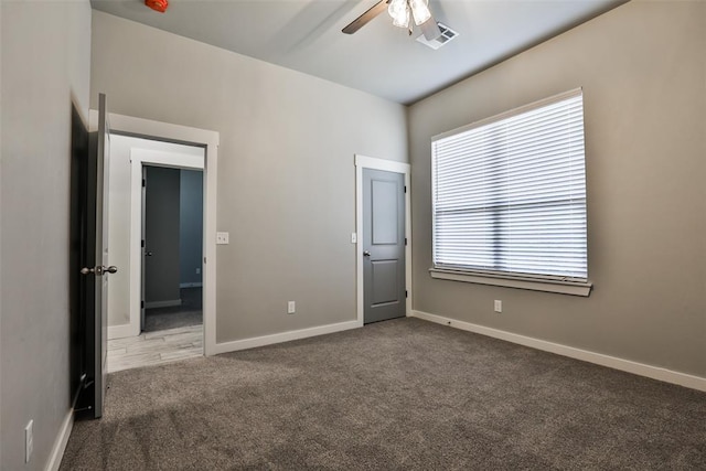 unfurnished bedroom featuring ceiling fan and carpet