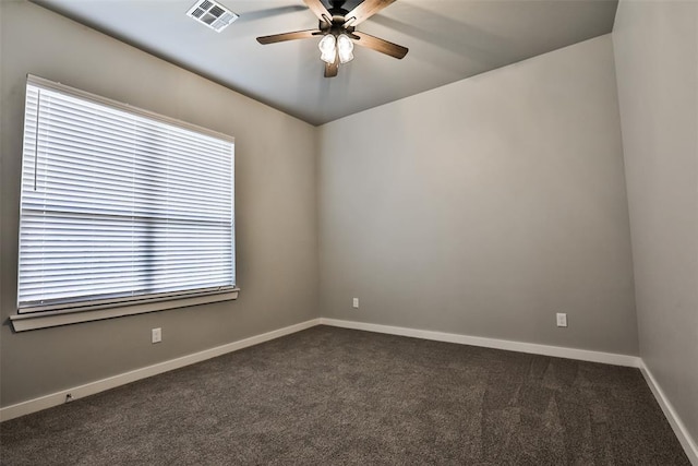 unfurnished room featuring dark colored carpet and ceiling fan