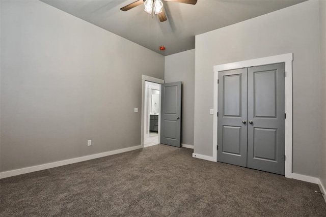 unfurnished bedroom featuring ceiling fan, dark carpet, and a closet