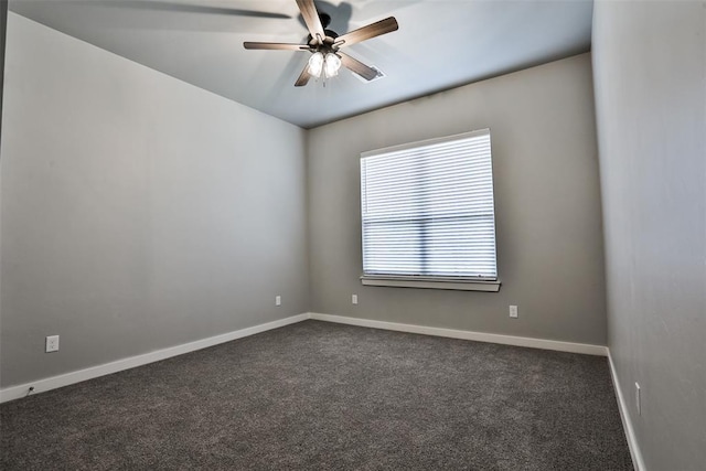 empty room with dark colored carpet and ceiling fan